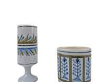 pair of white and blue vases with designs on them on a white background