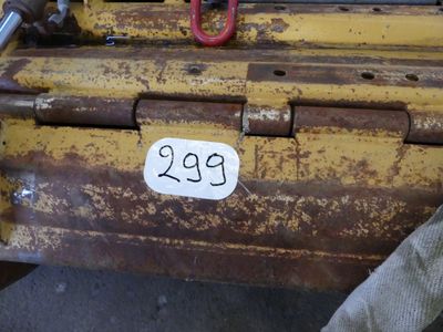 a close up of a fork and a number plate on the back of a tractor