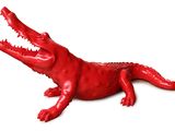 un alligator rouge allongé sur une surface blanche