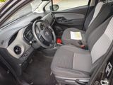 the interior of a small car with a steering wheel and a dashboard