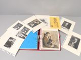 a lot of old black and white photos on a table
