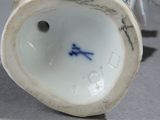 a white vase with a blue and white design on it