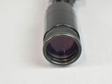 a close up of a telescope lens on a white surface