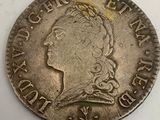 a close up of a silver coin with a crown on it