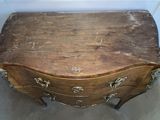 an old wooden chest of drawers in the corner of a room