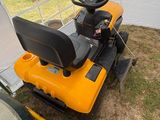 a close up of a lawn mower sitting in the grass