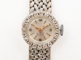 an image of a woman ' s wrist watch with a diamond bezel