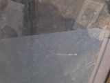a woman taking a picture through a window with a cell phone