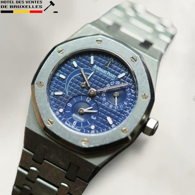 an image of a watch with a blue dial on a bracelet