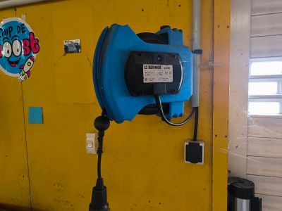 a blue blow dryer on a yellow wall in a room