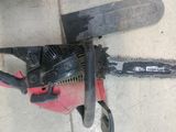 a chainsaw that is laying on the ground