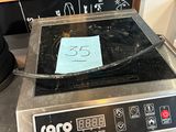 une photo d'une plaque de cuisson sur laquelle est posée une pancarte