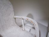 a white chair that is sitting in the corner of a room