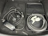 a car trunk with a bunch of wires and cords in it