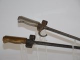 two swords that are on display on the wall