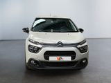 the front of a white citrole parked in a room