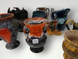 many vases that are lined up together on a table