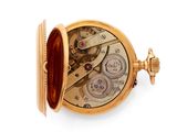 a gold pocket watch on a white surface with a white background