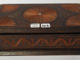 an old wooden box with a decorative design on the lid