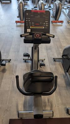 a row of stationary exercise bikes in a gym