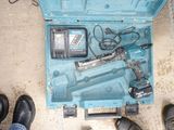 a blue tool box with tools in it and a pair of black shoes