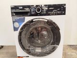 a close up of a washing machine on a pallet in a room