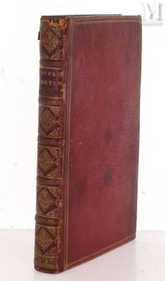 an old book sitting on top of a table next to a white wall