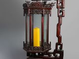 an old wooden lantern with a yellow candle inside of it
