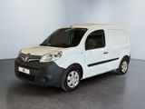 the small white van is parked in a large room