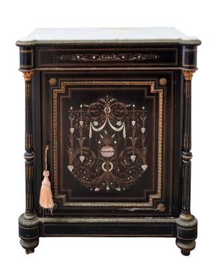a black cabinet with a marble top and gold trimmings