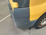a yellow and black truck parked in a parking lot