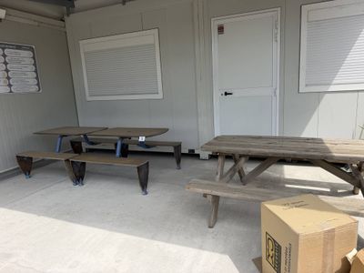 two picnic tables and two benches in a room