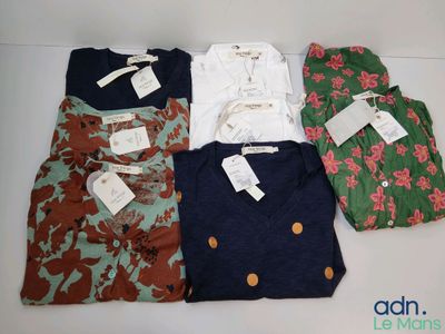 four shirts are laid out on a table with tags on them