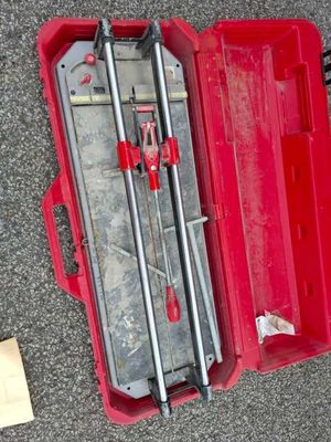 a red tool box with tools in it on the ground