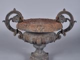 a small metal bowl with a handle on a stand