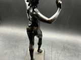 statue of a woman holding a tennis racquet on a marble base