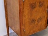 a small wooden cabinet with a door on it