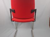an image of a red office chair against a white backdrop