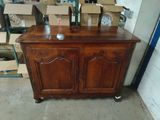 a wooden cabinet that has a clock on top of it