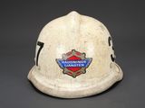 an old fireman ' s helmet with a badge on it