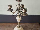 an antique brass candelabra with marble balls and candles