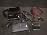 many different types of purses and wallets laid out on the floor