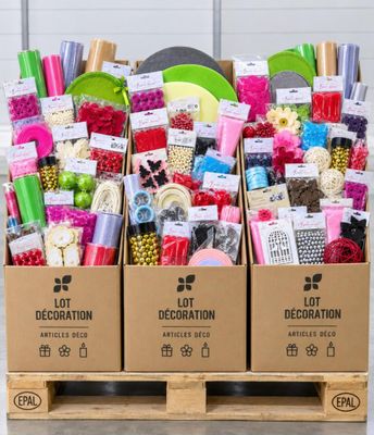 a box filled with lots of craft supplies sitting on top of a wooden pallet