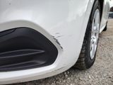 a close up of a car ' s front bumper and tire
