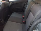 the back seat of a car with a seat belt in the back of it