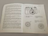 an open book with a drawing of a camera on it