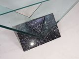 a glass table with a black marble top and a glass shelf