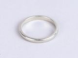 silver ring with a thin band on a white surface