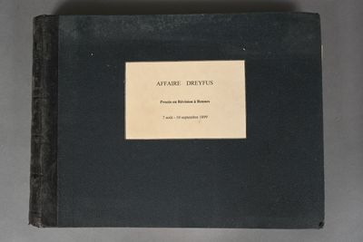 an old book sitting on a table with a label on it