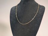 necklace on a mannequin stand on a white background
